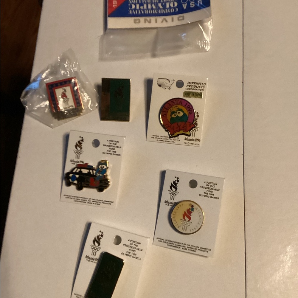 Collection of Atlanta 1996 pins and  coin